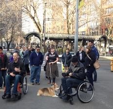 A crowd at Pioneer Square Park, including people using wheelchairs and other mobility devices